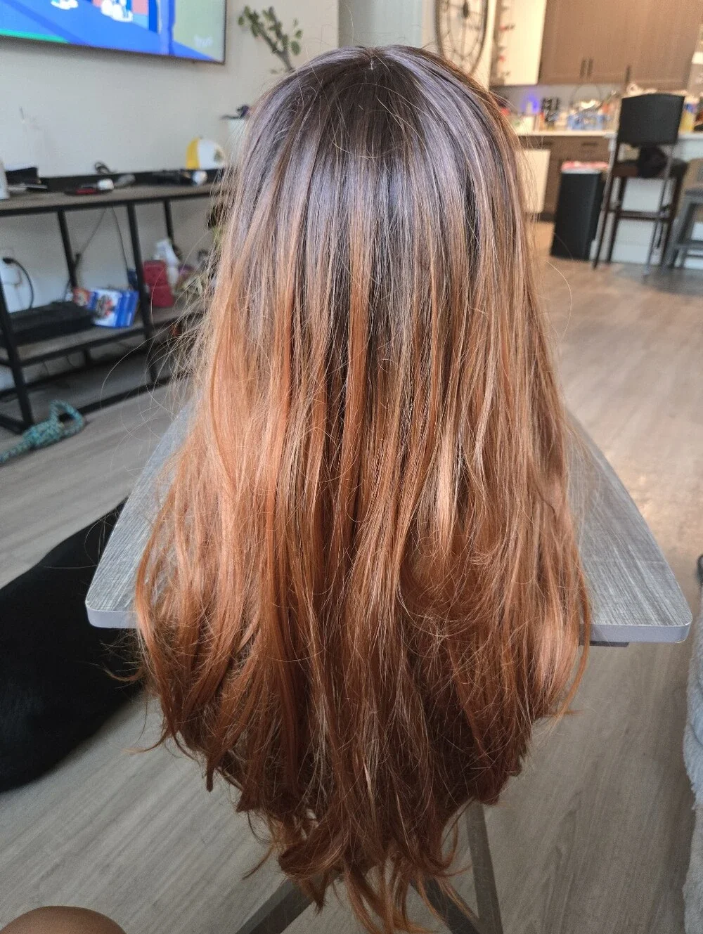 long auburn wig with dark brown roots and face-framing wispy bangs Sunthetic
